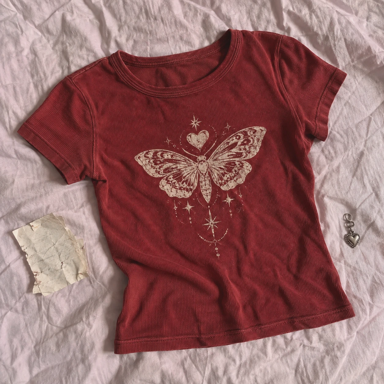 Washed cherry fitted baby tee with a hand printed moth-heart emblem